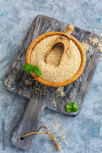 Raw organic quinoa seeds in a wooden bowl. photo