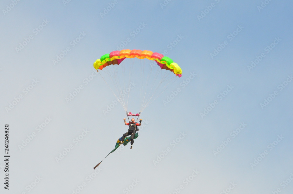 Parachutist going to land holding the brazilian flag during flight. Parachutist going to land holding the brazilian flag during flight.