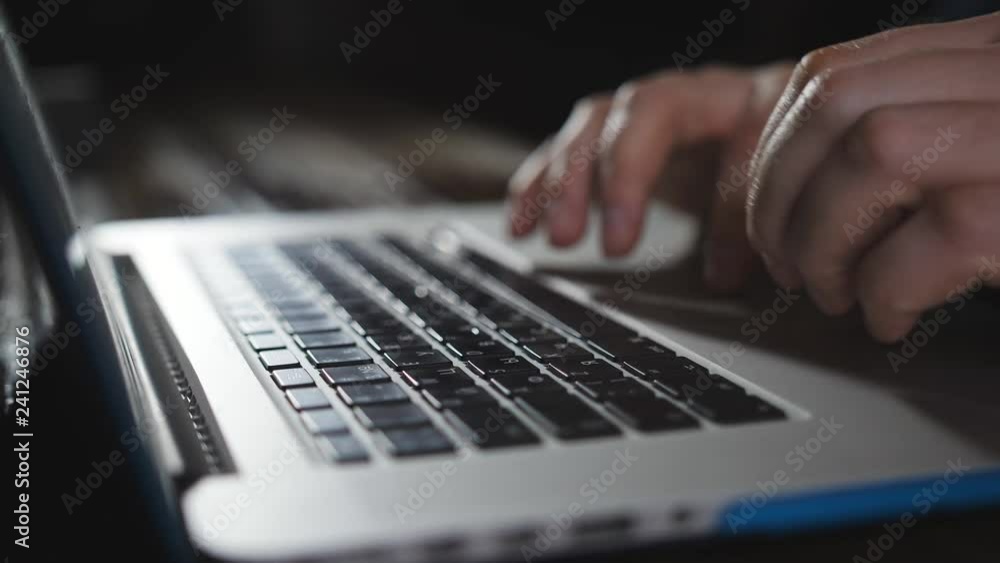 Close-up of male hands typing on the keyboard. Office worker. The writer prints the text on the laptop keyboard. Close-up of male hands typing on the keyboard. Office worker. The writer prints the text on the laptop keyboard.