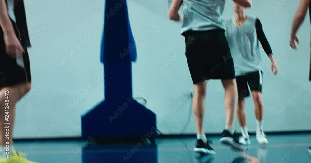 High school team playing basketball indoors, practicing combinations and drills. 4K UHD High school team playing basketball indoors, practicing combinations and drills. 4K UHD