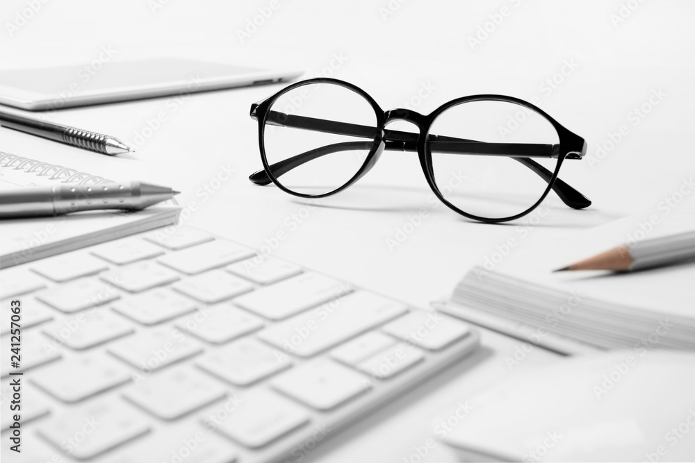 Office supplies, Glasses at a desk with a computer keyboard , business concept