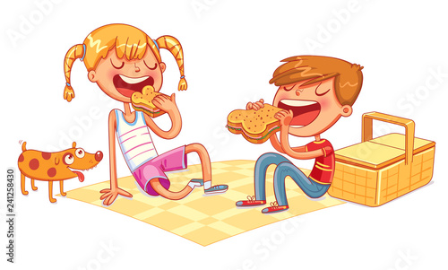 Boy and girl with puppy eating sandwiches on picnic