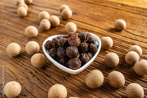 Dried longan and flesh on wooden table photo
