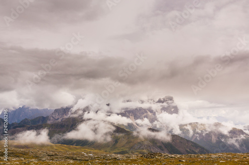 Beautiful scenery in the Dolomite Alps, with rain clouds, mist, and limestone peaks © Calin Tatu