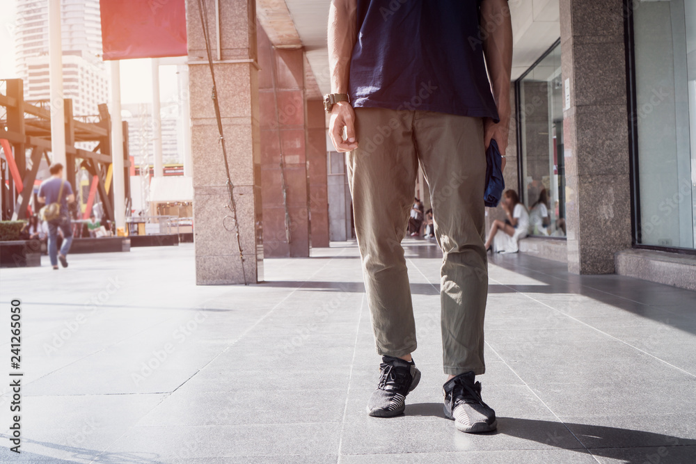 Obraz premium Young Man Asian traveler walking at department store on vacation exploring Bangkok Thailand city. Travel holiday lifestyle concept.