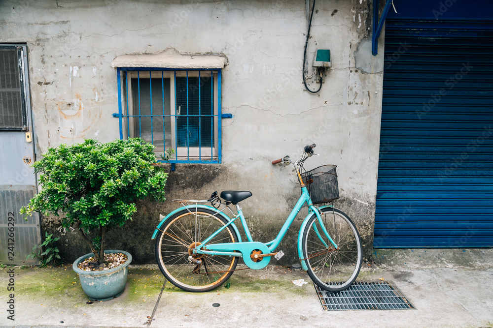 Vintage bicycle against old house wall in Taipei, Taiwan