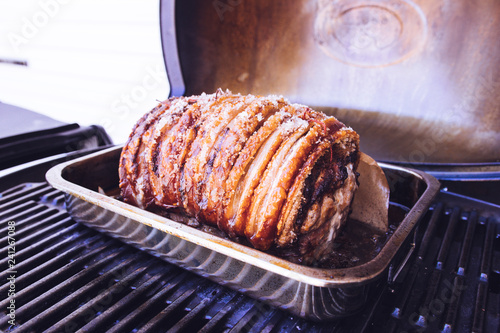 Фотография Roasted Pork with crackling skin in an oven roasting tin
