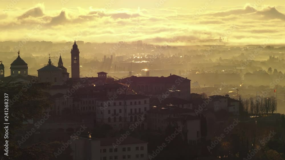 Bergamo, one of the most beautiful city in Italy. Amazing landscape of the old town and the fog covers the plain at sunrise Bergamo, one of the most beautiful city in Italy. Amazing landscape of the old town and the fog covers the plain at sunrise