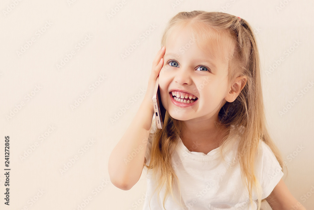 Cute Little girl using mobile phone at home Cute Little girl using mobile phone at home