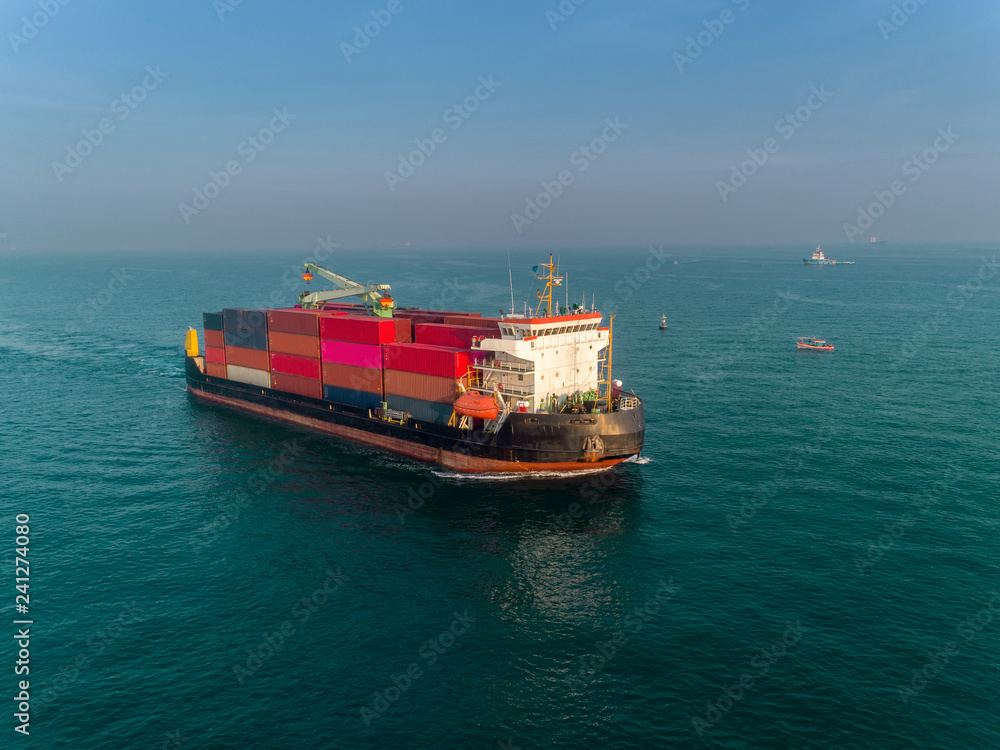 Container ship on the sea port and working crane bridge load full of container for logistics import export, shipping or transportation.