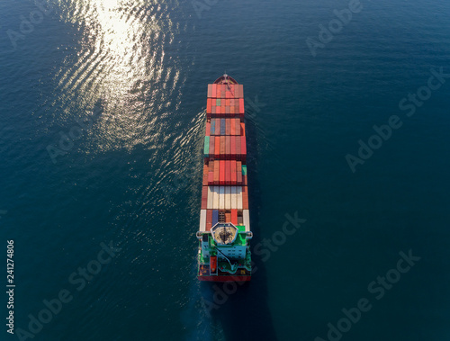 Aerial top view container ship going to crane bridge for unload container for logistics import export, shipping or transportation.