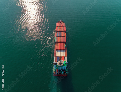 Aerial top view container ship going to crane bridge for unload container for logistics import export, shipping or transportation.