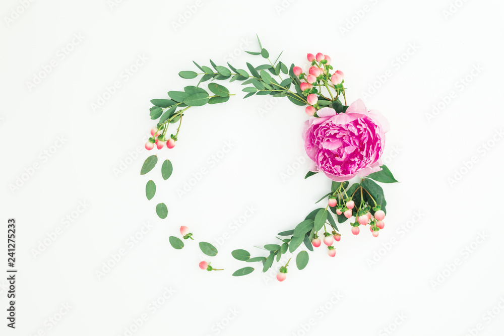 Floral round frame with pink peony, hypericum and eucalyptus on white background. Flat lay, top view