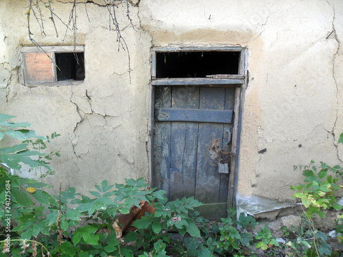 Old abandoned clay house door © sergeyD