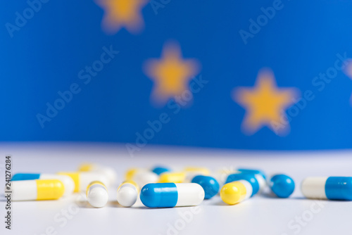 White and blue pills on a blue background