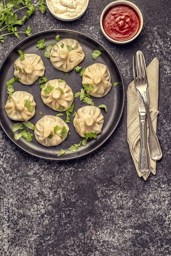 Traditional steamed dumplings Khinkali with Tomato and Tartar sauce