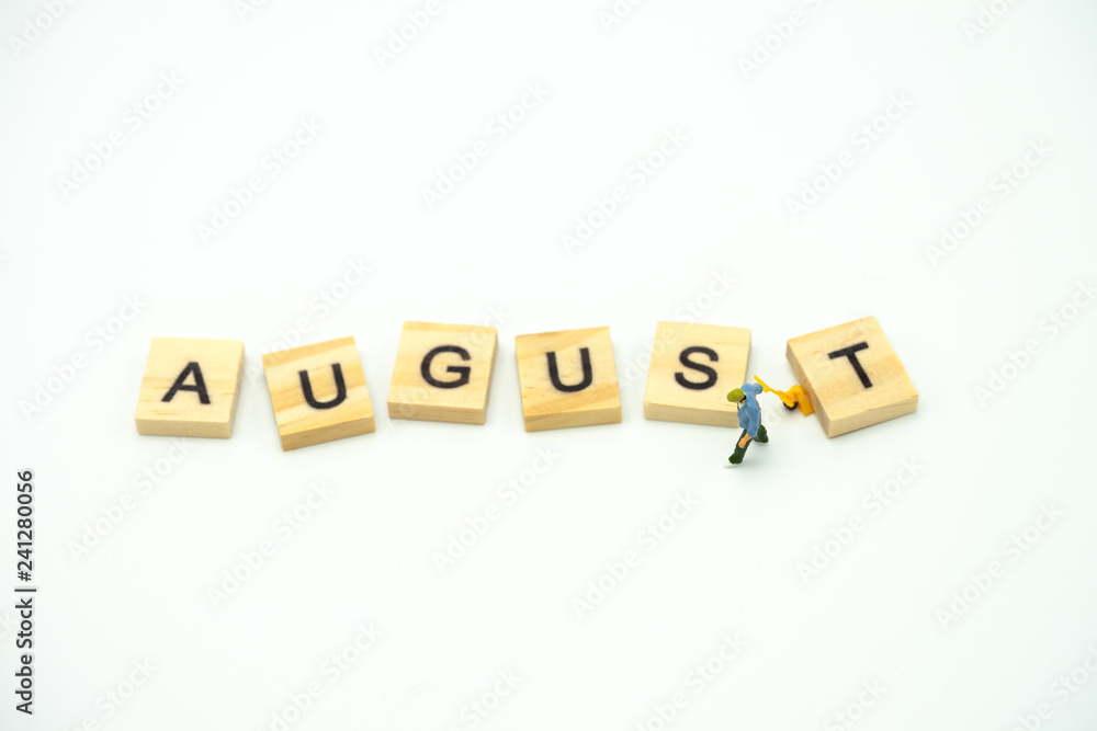 Miniature people Construction worker standing with wood word Month. using as background business concept and calendar concept with copy space for your text Miniature people Construction worker standing with wood word Month. using as background business concept and calendar concept with copy space for your text