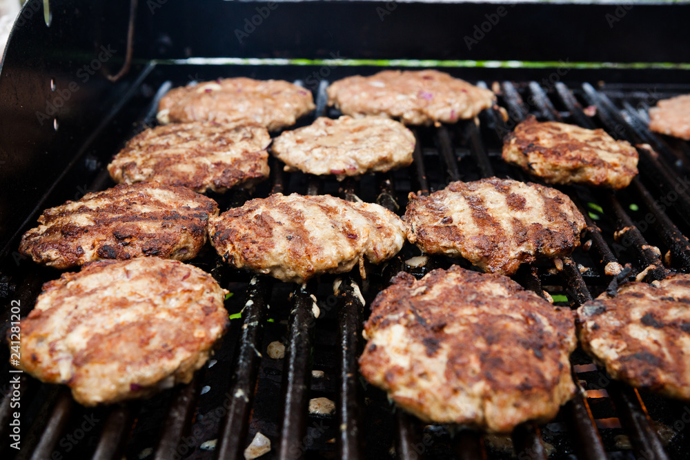 Homemade delicious minced meat steaks on grill Homemade delicious minced meat steaks on grill