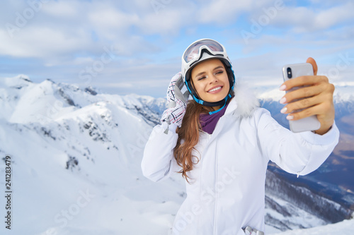 Young woman taking a selfie in winter holiday in mountain.Young woman taking a selfie in winter holiday in mountain.
