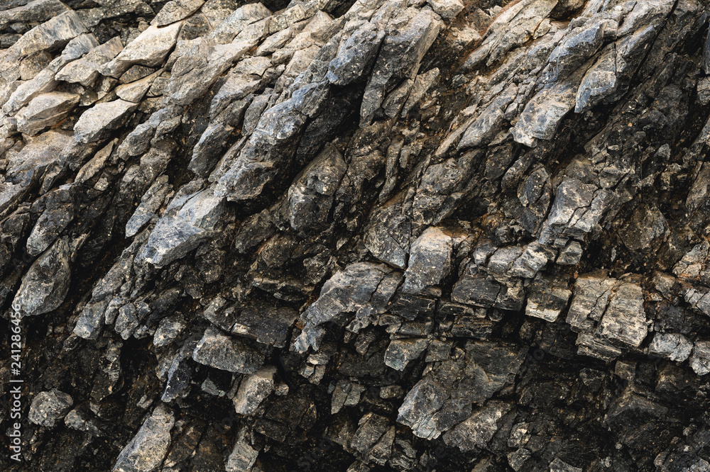 Textured basalt background thin stone fibers in the cut. natural volcanic formations Textured basalt background thin stone fibers in the cut. natural volcanic formations