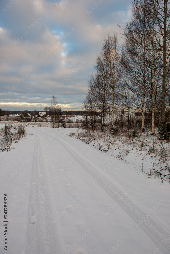 snow covered winter road with tire tracks snow covered winter road with tire tracks