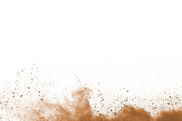 Brown color powder explosion on white background. Colored cloud. Colorful dust explode. Paint Holi.