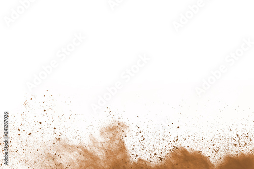 Brown color powder explosion on white background. Colored cloud. Colorful dust explode. Paint Holi. photo