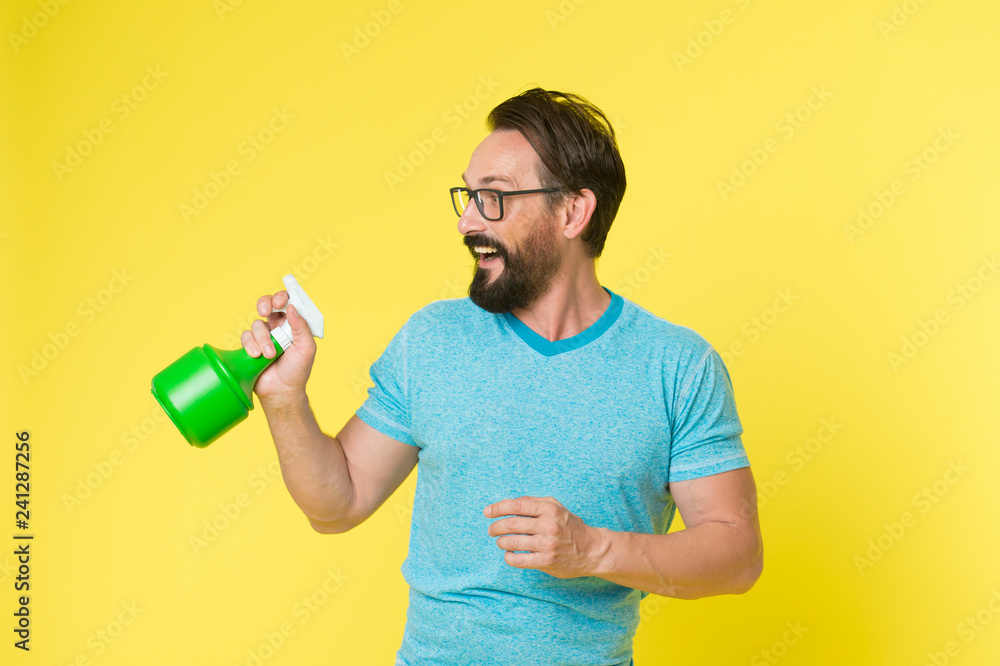 Bearded man with eyeglasses refresh sprinkling water. Man refresh with spray bottle yellow background. Time to refresh yourself. Heat season. Hot and thirst. On guard of freshness. Refresh concept Bearded man with eyeglasses refresh sprinkling water. Man refresh with spray bottle yellow background. Time to refresh yourself. Heat season. Hot and thirst. On guard of freshness. Refresh concept