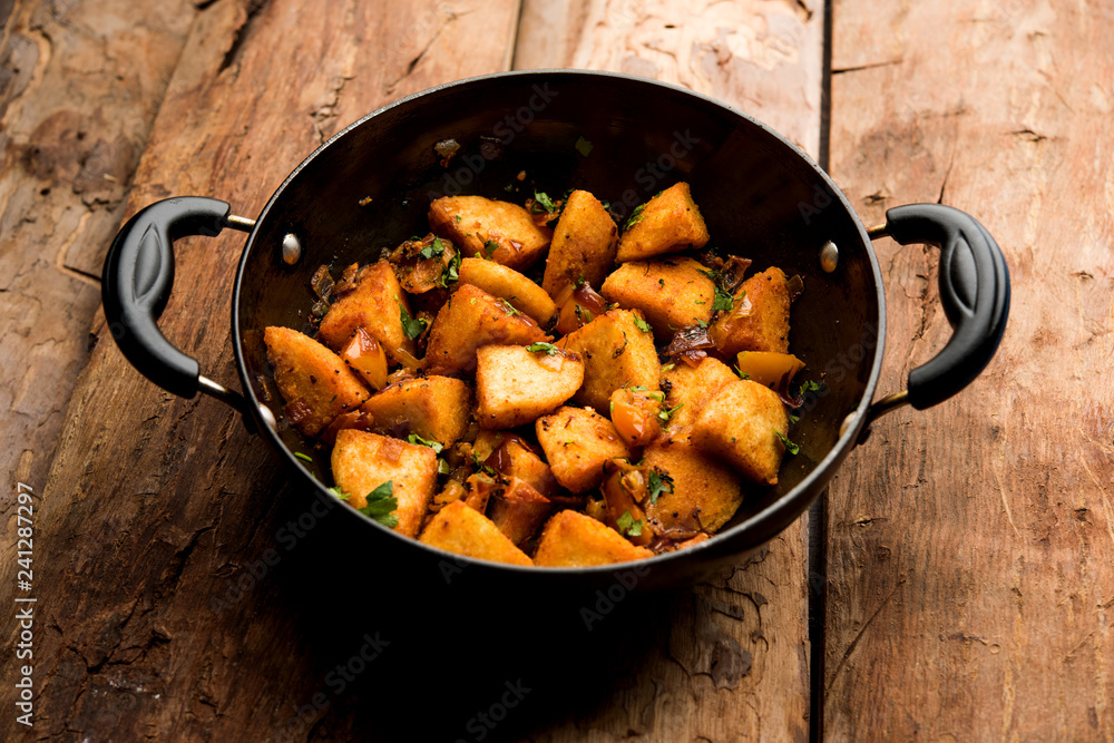 Masala fried Idlies or Idli fry - south indian Snack made using with leftover idly served with tomato ketchup. selective focus Masala fried Idlies or Idli fry - south indian Snack made using with leftover idly served with tomato ketchup. selective focus