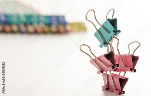 Man, from multi-colored office clips for paper on white background selective focus