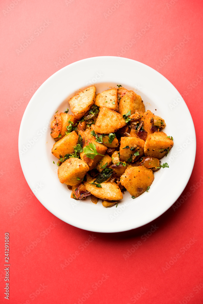 Masala fried Idlies or Idli fry - south indian Snack made using with leftover idly served with tomato ketchup. selective focus Masala fried Idlies or Idli fry - south indian Snack made using with leftover idly served with tomato ketchup. selective focus
