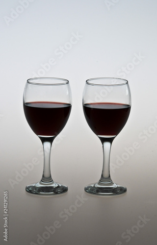  two glasses of red wine on the table 