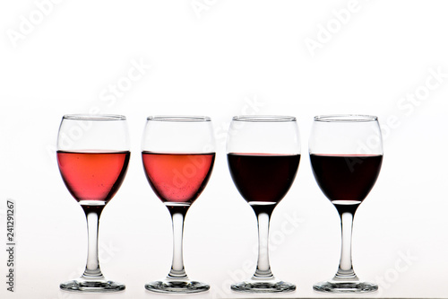 two glasses of red and two pink wine