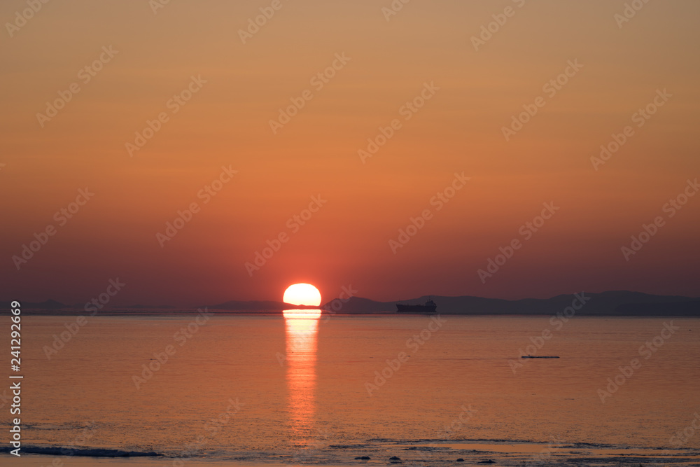 Seascape in orange and with bright sun on the horizon. Seascape in orange and with bright sun on the horizon.