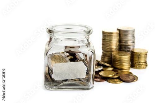 Full jar of coins  with blank label. Savings concept