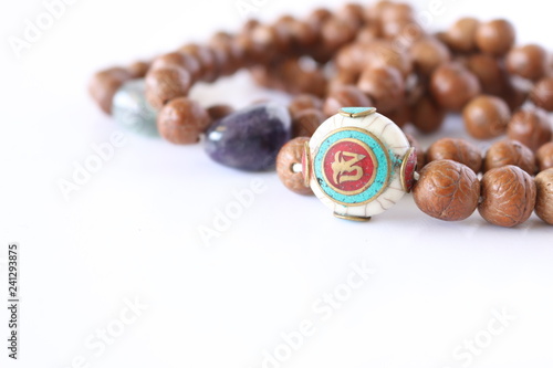 Om mala with whitew and green om bead on white background,Tibetan mala beads for prayers photo