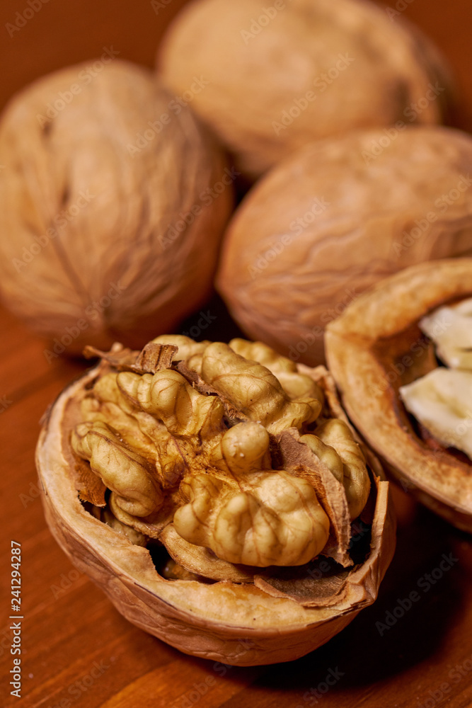 Walnut on brown wooden background. Selective focus Walnut on brown wooden background. Selective focus