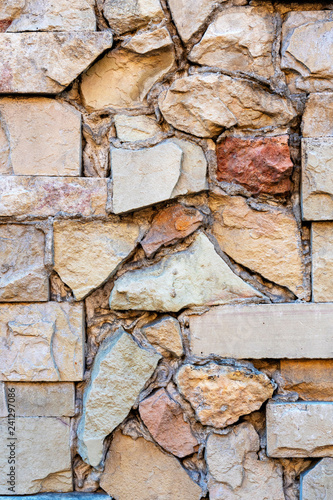 Close-up photo. Fragment of masonry wall with decorative stone trim.