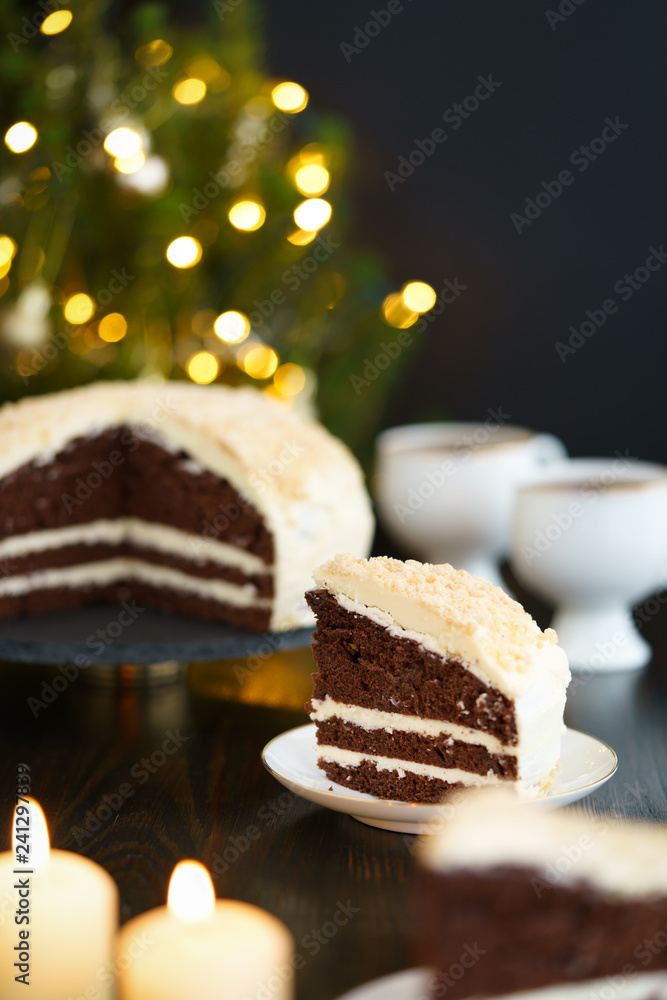 Chocolate cake with butter frosting and crushed nuts. Served on a porcelain plate, high resolution Chocolate cake with butter frosting and crushed nuts. Served on a porcelain plate, high resolution