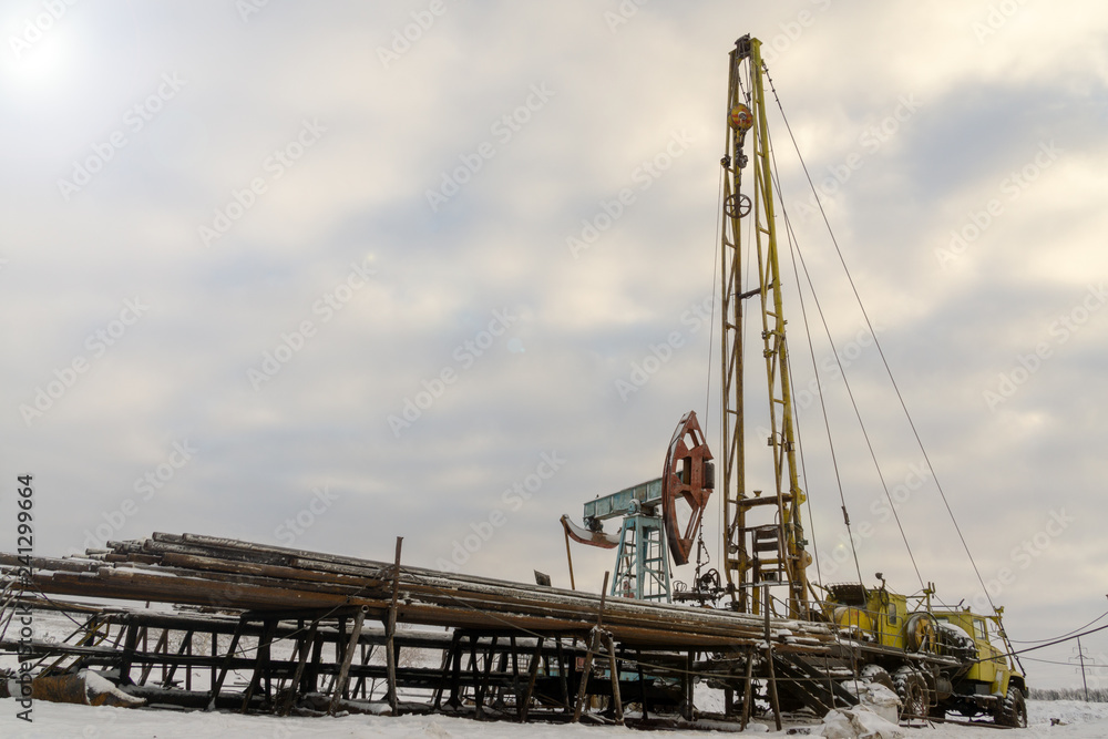 Fototapeta premium Mining and quarrying. Installations for the extraction of oil from the bowels of the Earth. Pumpjack is the overground drive for a reciprocating piston pump in an oil well. 