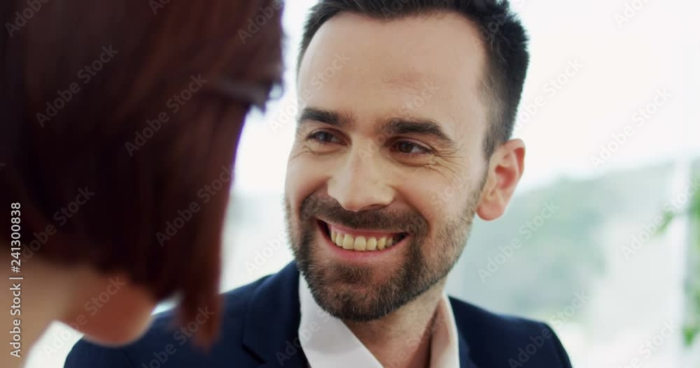 Portrait of the handsome Caucasian happy smiled man asking a woman to marry him with a red box with a ring inside. Portrait of the handsome Caucasian happy smiled man asking a woman to marry him with a red box with a ring inside.