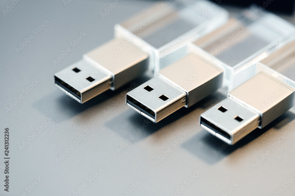 Stylish Flash Drive. Several glass card on a gray background. Macro Stylish Flash Drive. Several glass card on a gray background. Macro