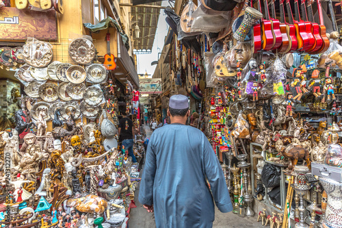 Cairo, Egypt - Nov 2nd 2018 - A local arab walking through local souvenirs stores with plenty of gifts in Cairo, Egypt