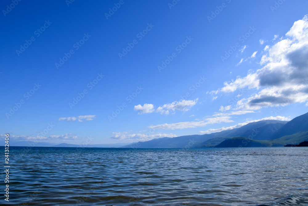 Landscape of Ohrid lake with mountain background. Pogradec, Tushemisht, Albania.