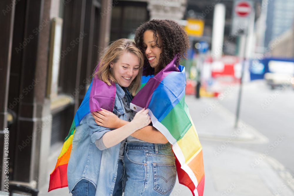 Lesbian couple with a LGBT flag