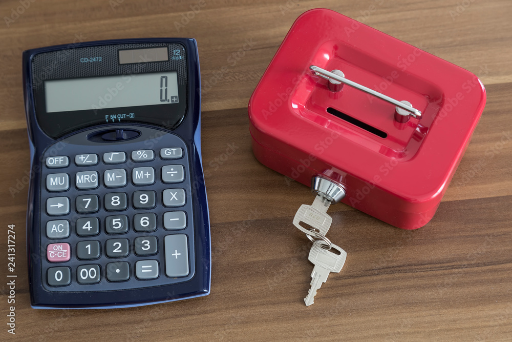 accumulate for poor people or investment .coins,hand ,calculator and red moneybox on the white background for charity foundation concept.person throwing money into piggy bank accumulate for poor people or investment .coins,hand ,calculator and red moneybox on the white background for charity foundation concept.person throwing money into piggy bank