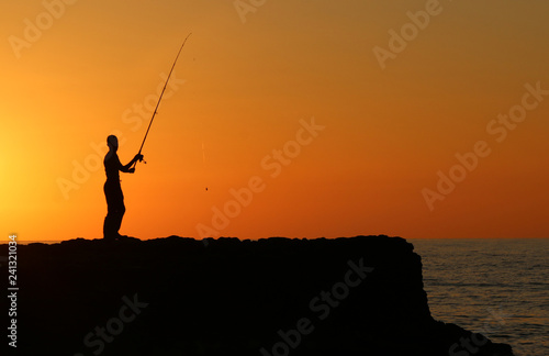 Fisherman at sunset © SERKAN