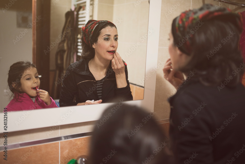 Mother and daughter make up their lips Mother and daughter make up their lips