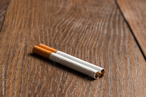 Cigarettes close-up on wooden brown background. The concept of smoking kills nicotine poisons. Copy space.