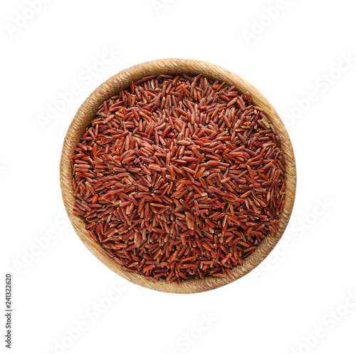 Wooden bowl with brown rice on white background, top view